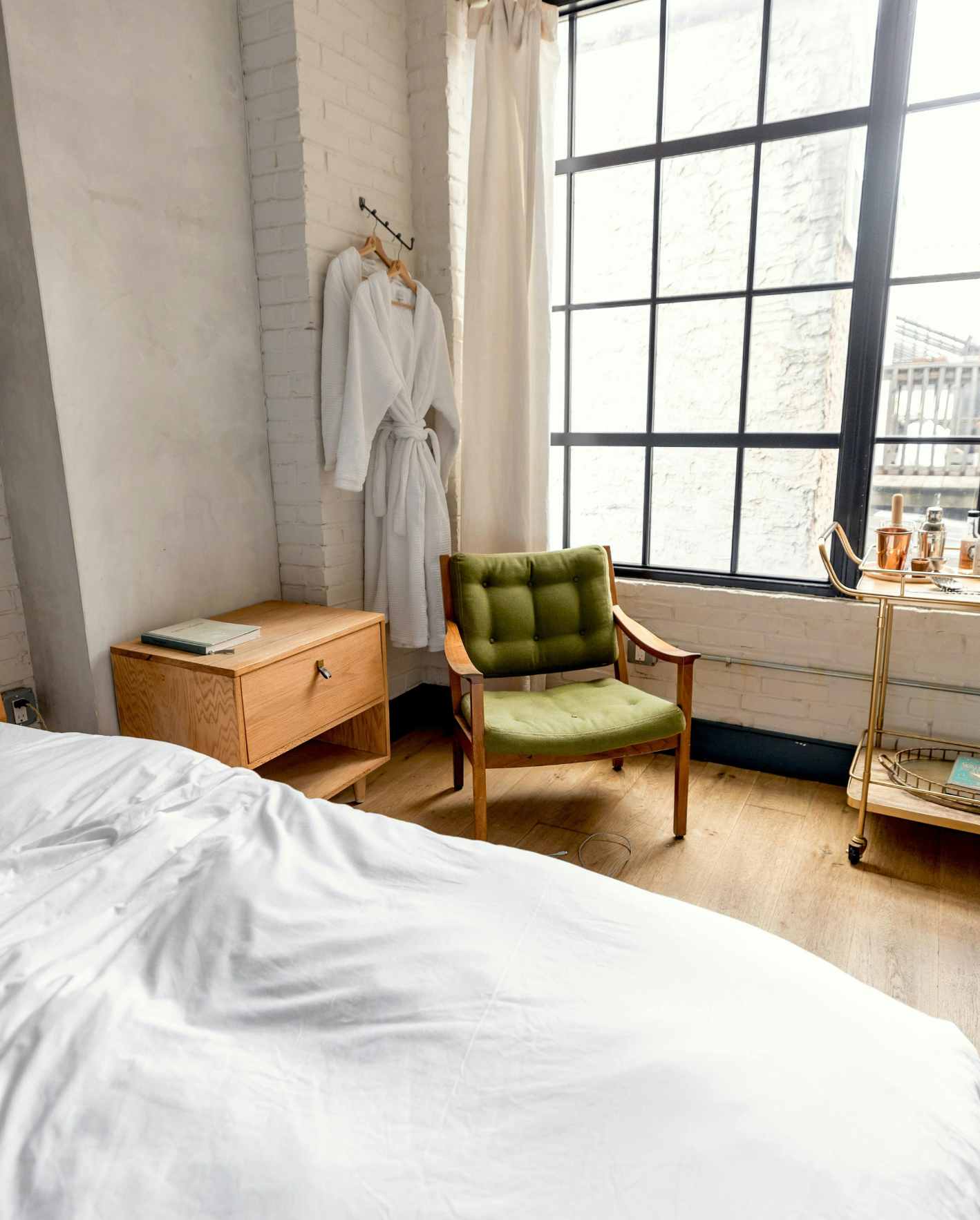 A bright, professionally prepared short-term rental bedroom with fresh linens, guest robes, and polished hospitality details, highlighting how Park Place Properties helps Miami Airbnb owners improve listing appeal, visibility, and booking performance.