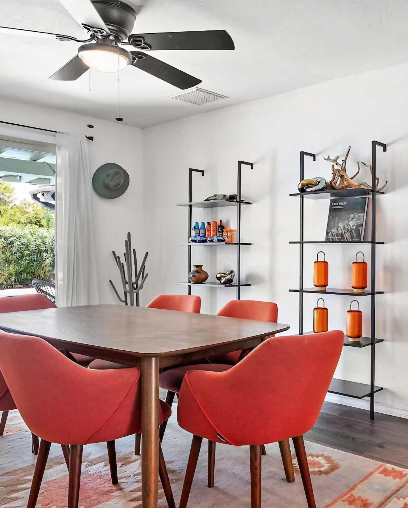 Modern Scottsdale Airbnb dining area with contemporary red seating, open-concept design, and professionally staged interior supporting seamless Airbnb booking system management.