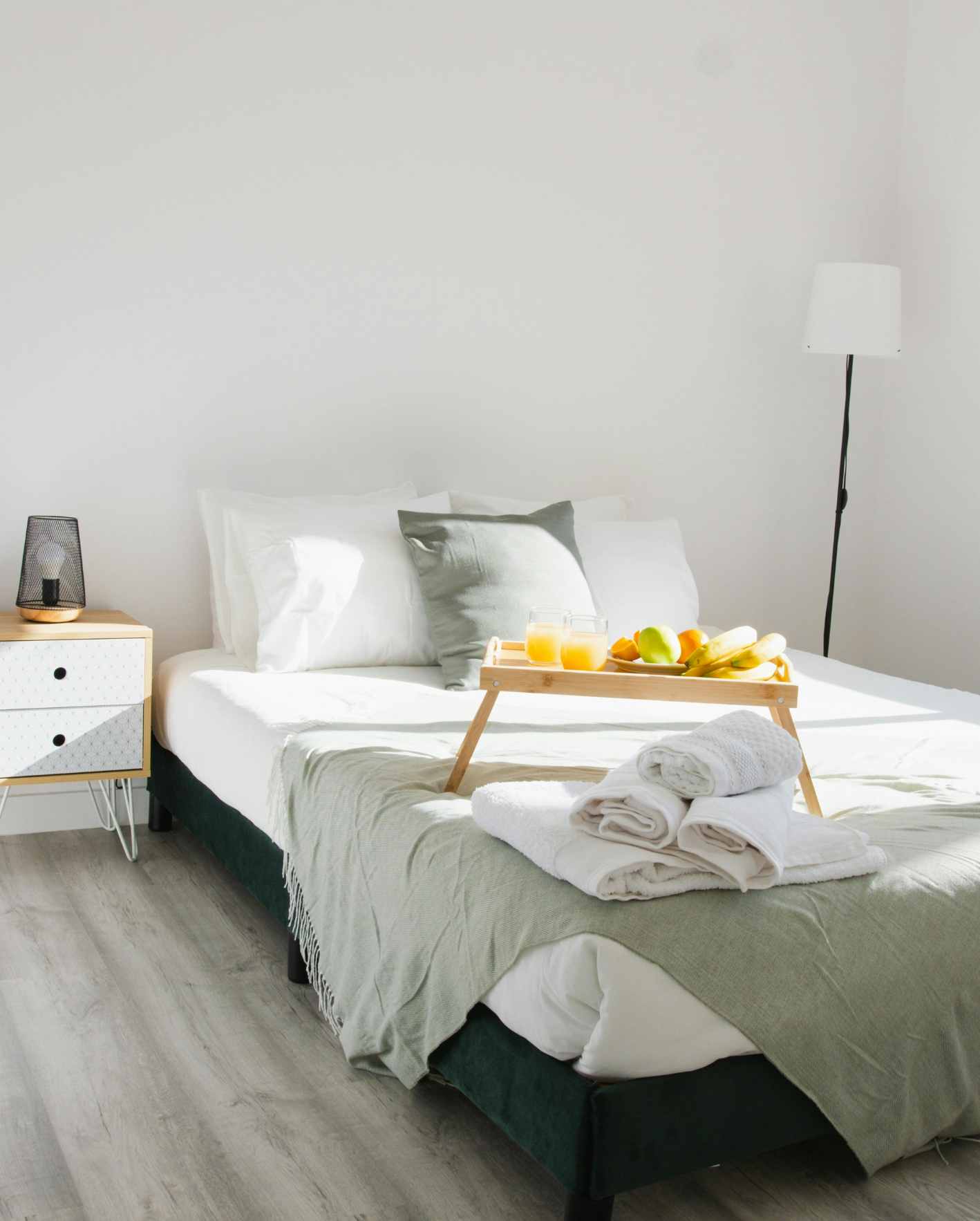 Clean Airbnb bedroom with fresh towels, breakfast tray, and guest-ready linens in a Scottsdale short-term rental.