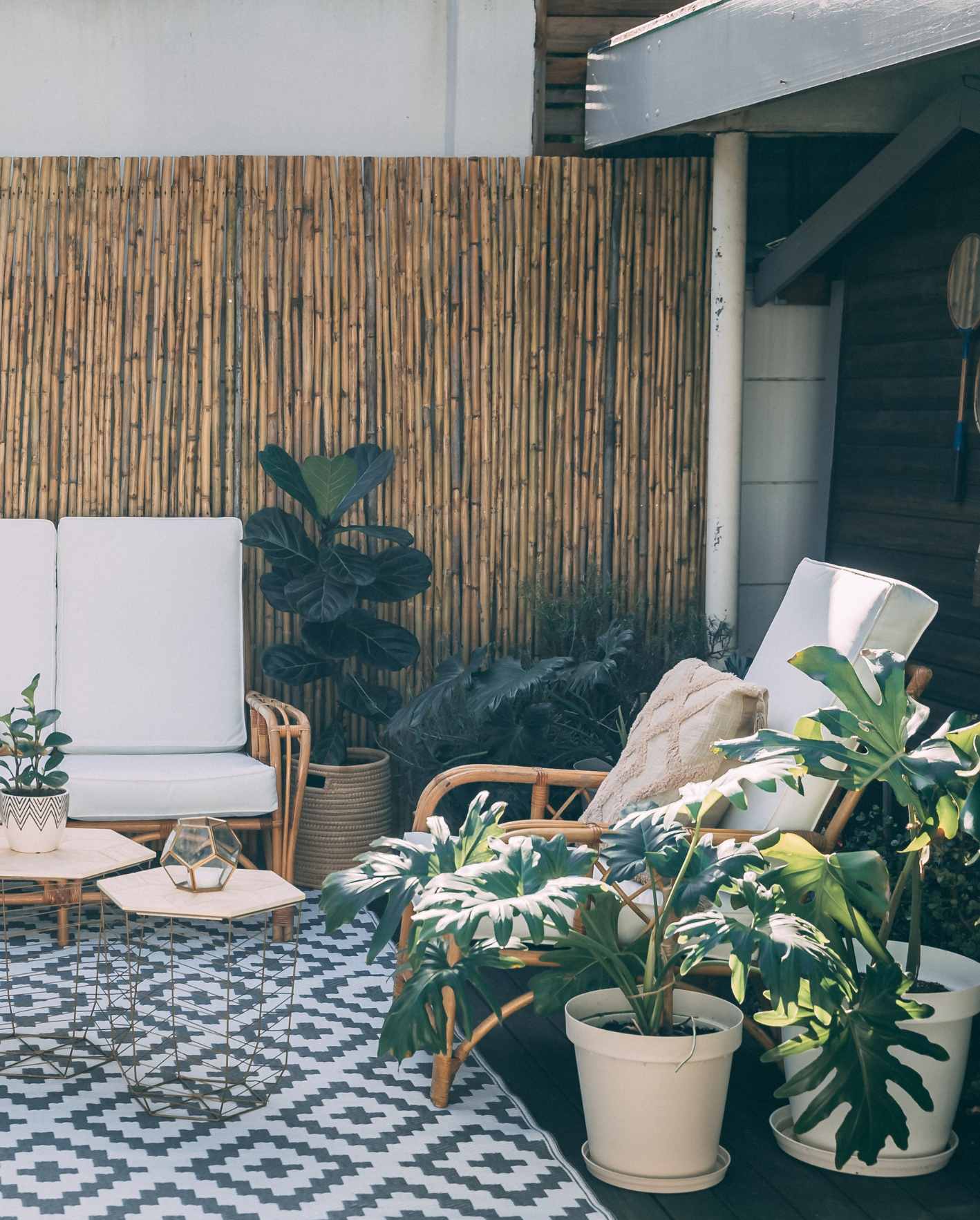 A professionally styled outdoor patio with tropical plants, lounge seating, and guest-ready details, highlighting how Park Place Properties helps Miami Airbnb owners deliver a polished guest experience with hands-off hosting support.
