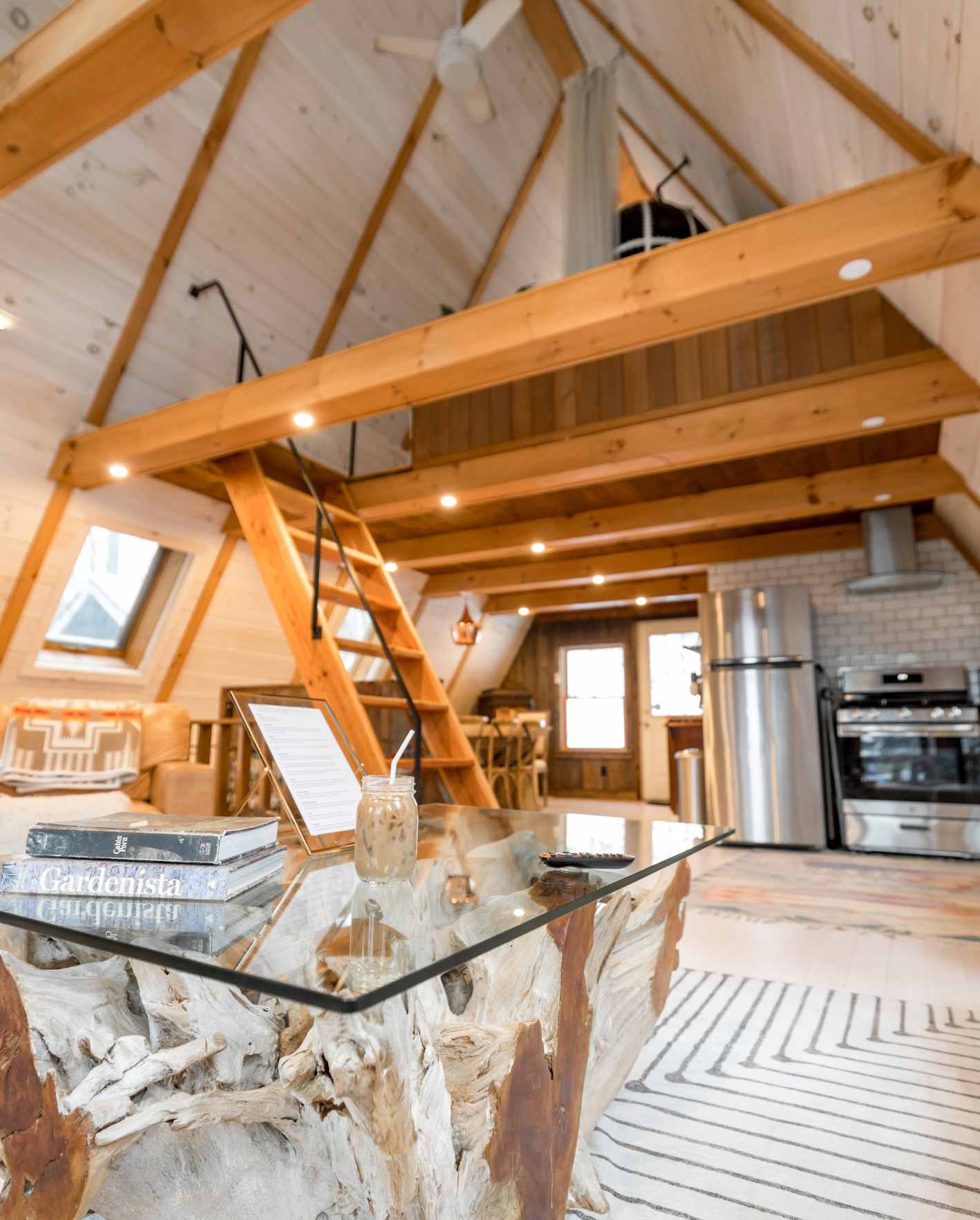 A warm, professionally designed short-term rental interior with a loft layout, wood finishes, modern kitchen, and polished guest-ready details, highlighting how Park Place Properties helps Miami Airbnb owners improve property appeal, guest experience, and booking performance.