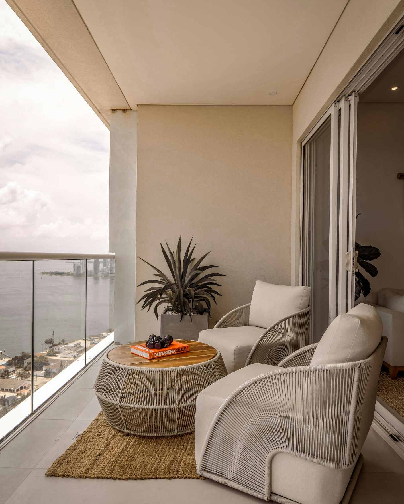 A polished Miami short-term rental balcony with water views and guest-ready seating, highlighting how Park Place Properties helps Airbnb owners launch, manage, and operate rental properties with professional licensing and compliance support.