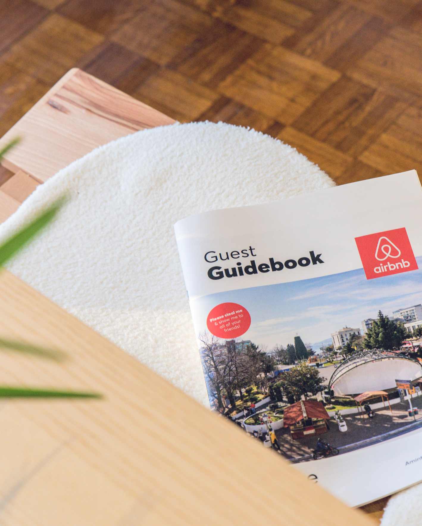 Airbnb guest guidebook beside a fresh towel in a professionally managed short-term rental.